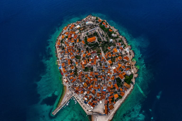 Aerial view of Primošten, Croatia, with its old town peninsula surrounded by the Adriatic Sea.